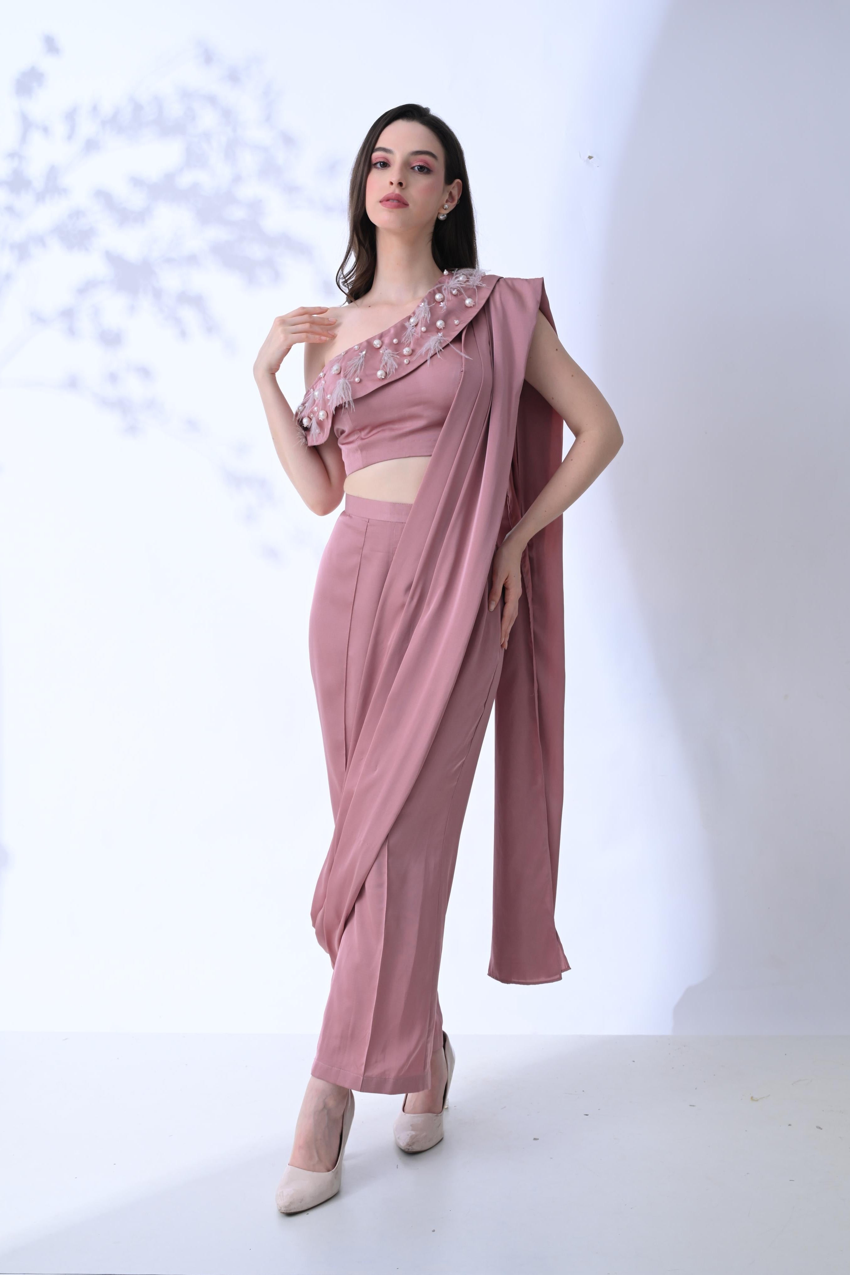 Woman wearing a pink saree with a white background